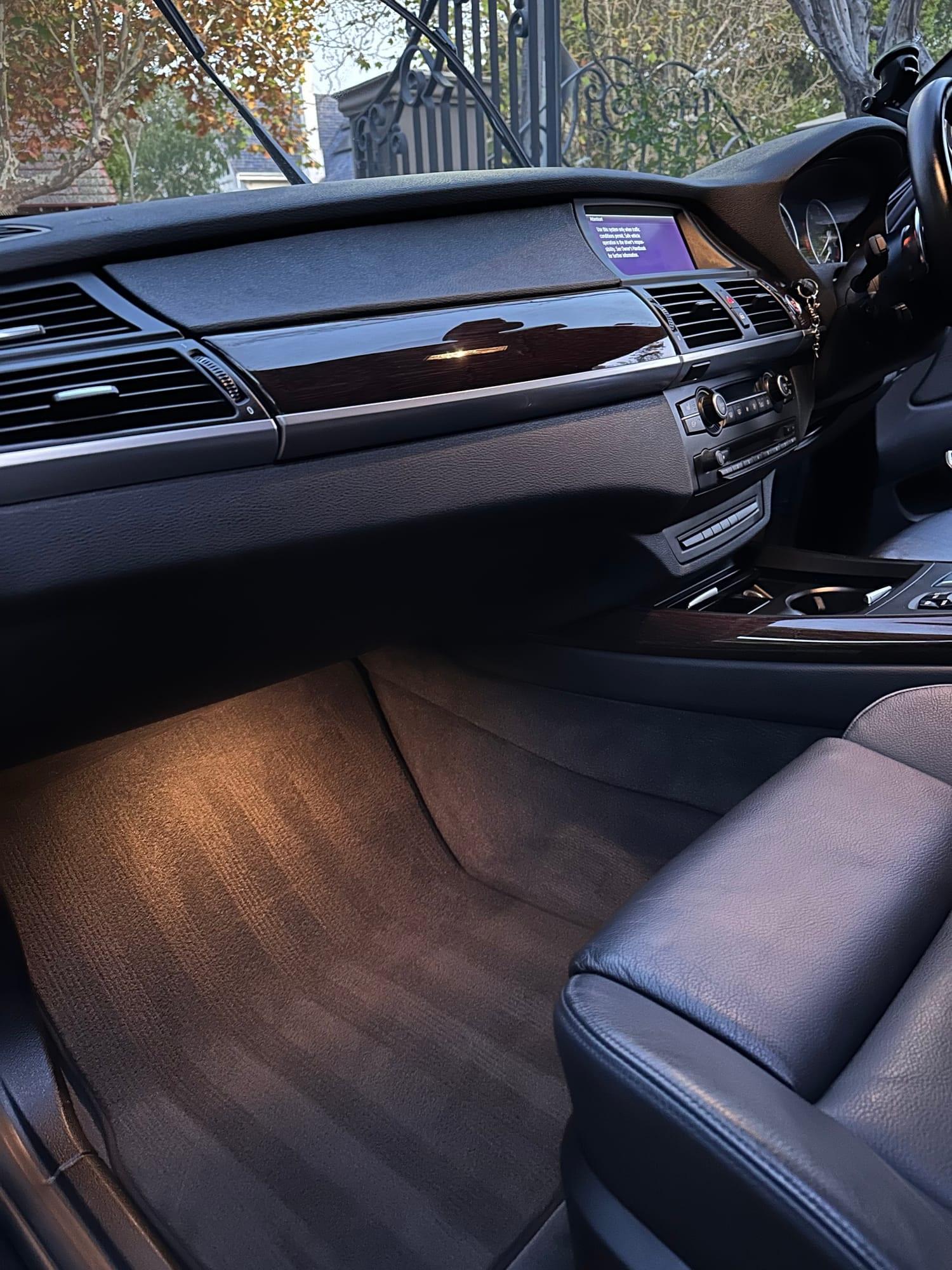 BMW X5 — passenger-side dash and carpet, after detailing