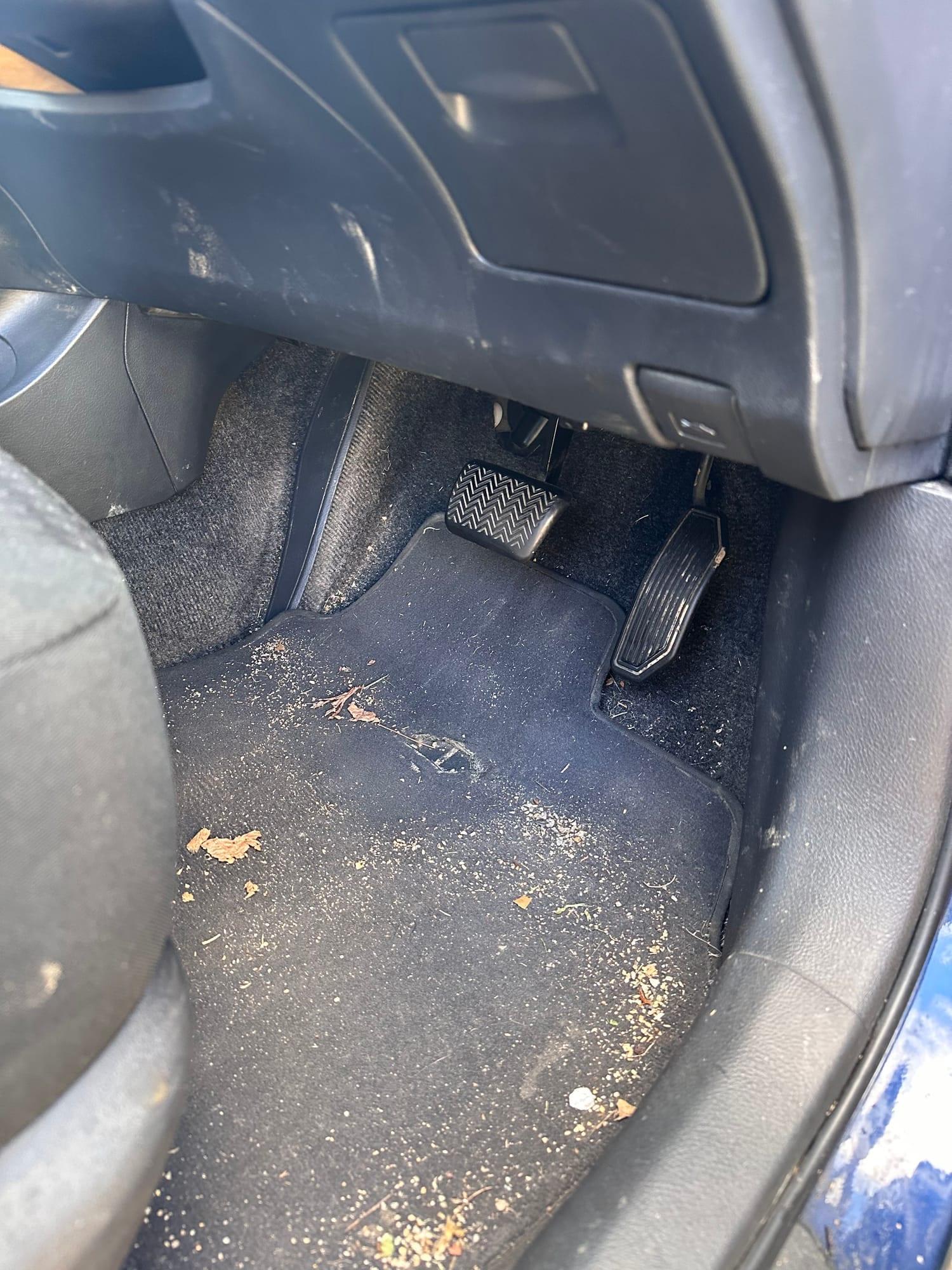 Toyota Corolla Sedan — driver's footwell before cleaning