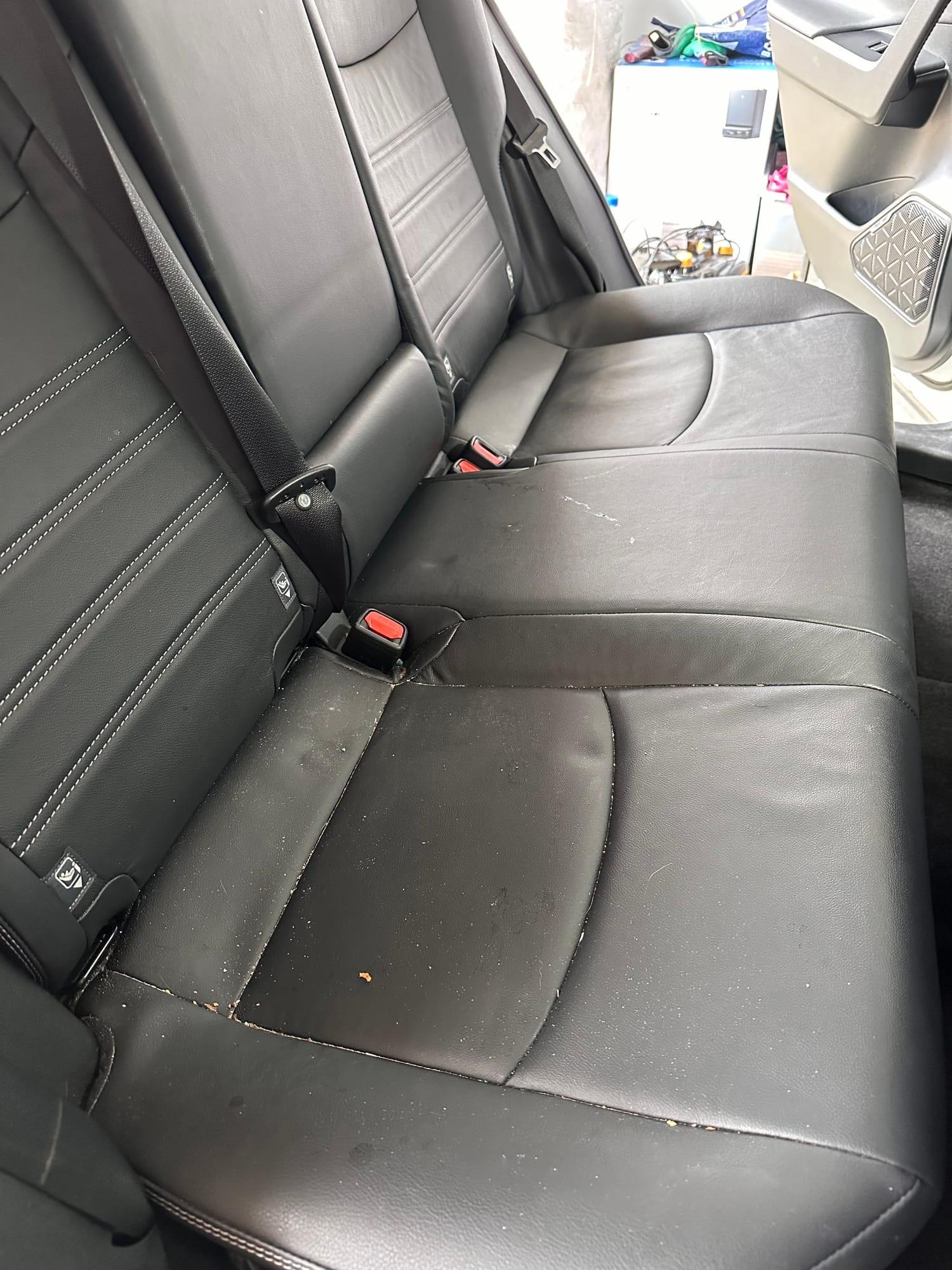 Toyota RAV4 — stained leather rear bench before cleaning