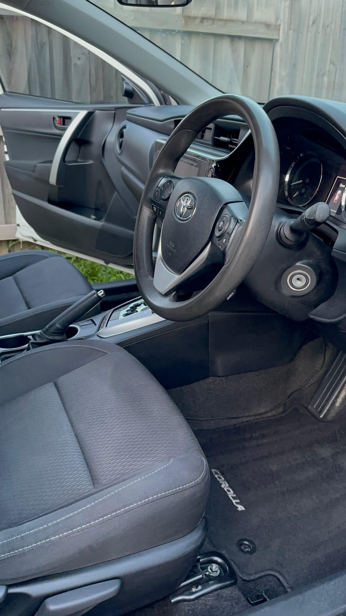Toyota Corolla — steering wheel, pedals and floor mat, after detailing