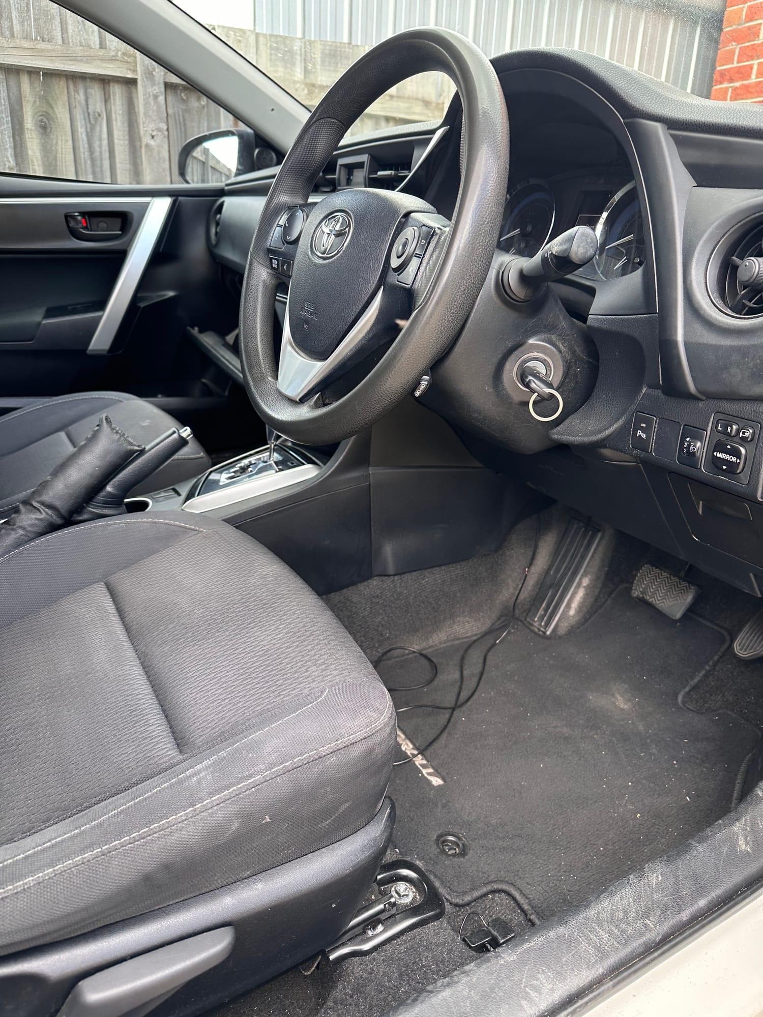 Toyota Corolla — steering wheel, pedals and floor mat, before detailing